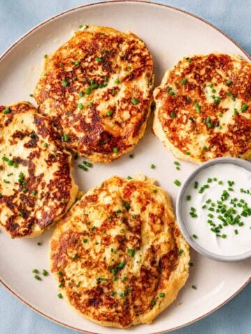 Crispy leftover mashed potato pancake ingredients mixed in a bowl with cheese, chives, egg, and seasonings
