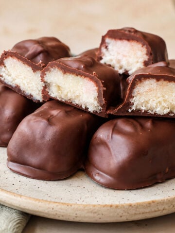 3 ingredient Mounds bars with chocolate coating and soft coconut filling on a ceramic plate