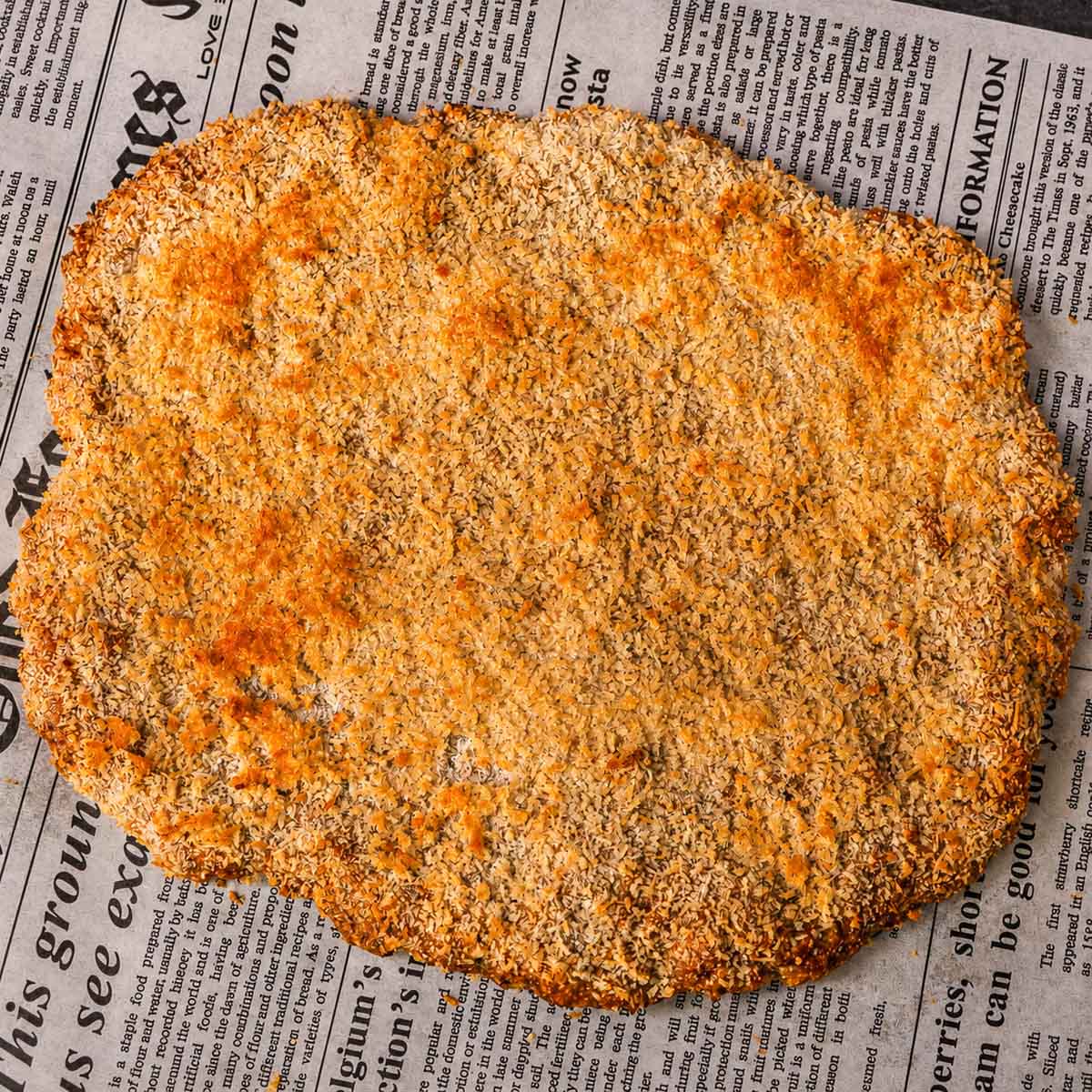 4 ingredient ground chicken cutlets coated in crispy golden panko breadcrumbs on parchment paper.