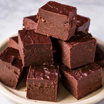 Cottage cheese fudge squares on a plate, smooth no-bake chocolate fudge made with 2 ingredients and high protein cottage cheese.