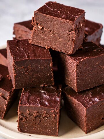 Cottage cheese fudge squares on a plate, smooth no-bake chocolate fudge made with 2 ingredients and high protein cottage cheese.