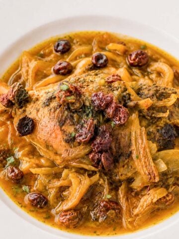 Moroccan chicken leg with raisins and onions served in a rich aromatic sauce
