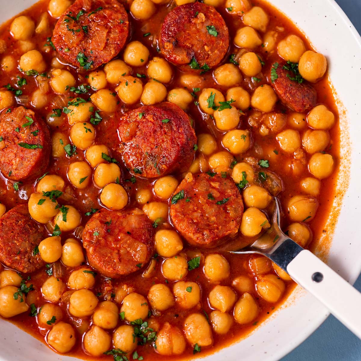 Chickpea and chorizo stew served with chickpeas, sliced chorizo and parsley