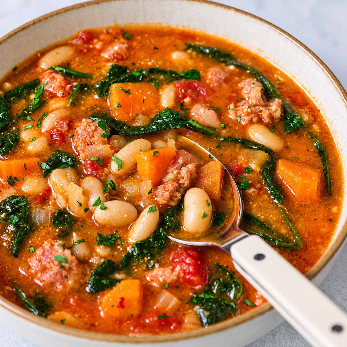 Italian sausage white bean soup with tomatoes and spinach