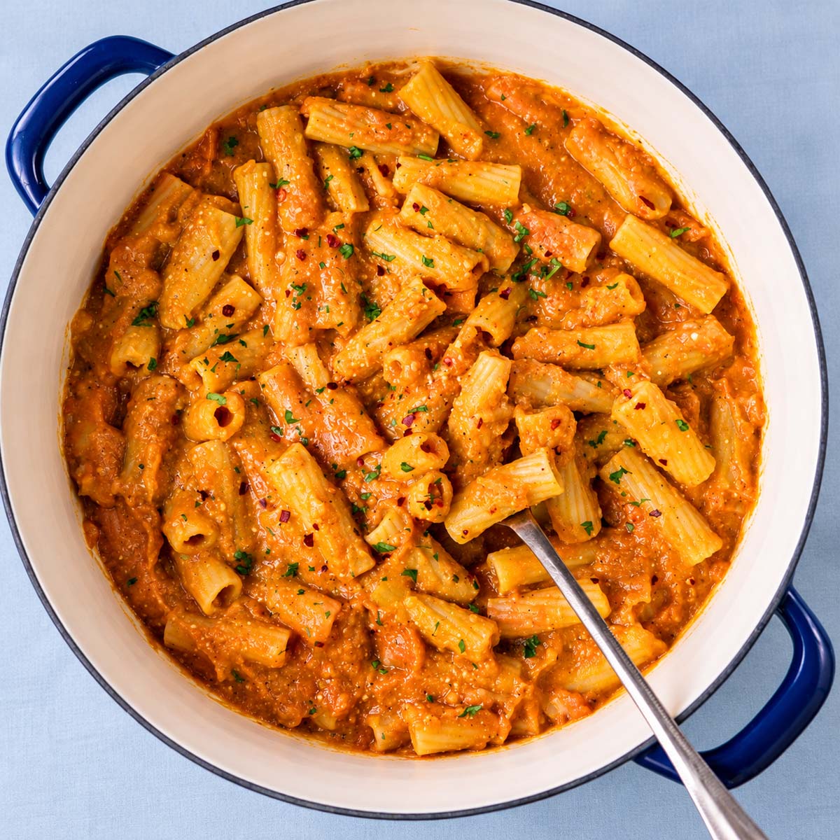 One pot pumpkin pasta with rigatoni coated in a creamy pumpkin sauce and sprinkled with fresh parsley and chili flakes.
